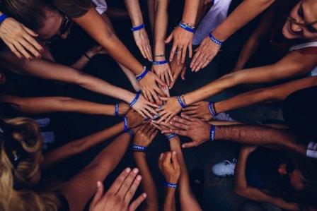 Photo of a bunch of hands coming together as a symbolism of corporate responsibility